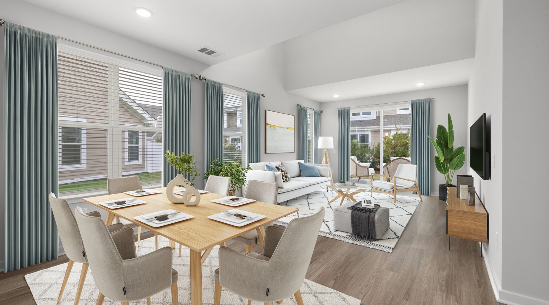 Living room and dining room with large windows at The Village at Compass Pointe townhouses for rent in Wilmington, NC Living room and dining room with large windows at The Village at Compass Pointe townhouses for rent in Wilmington, NC